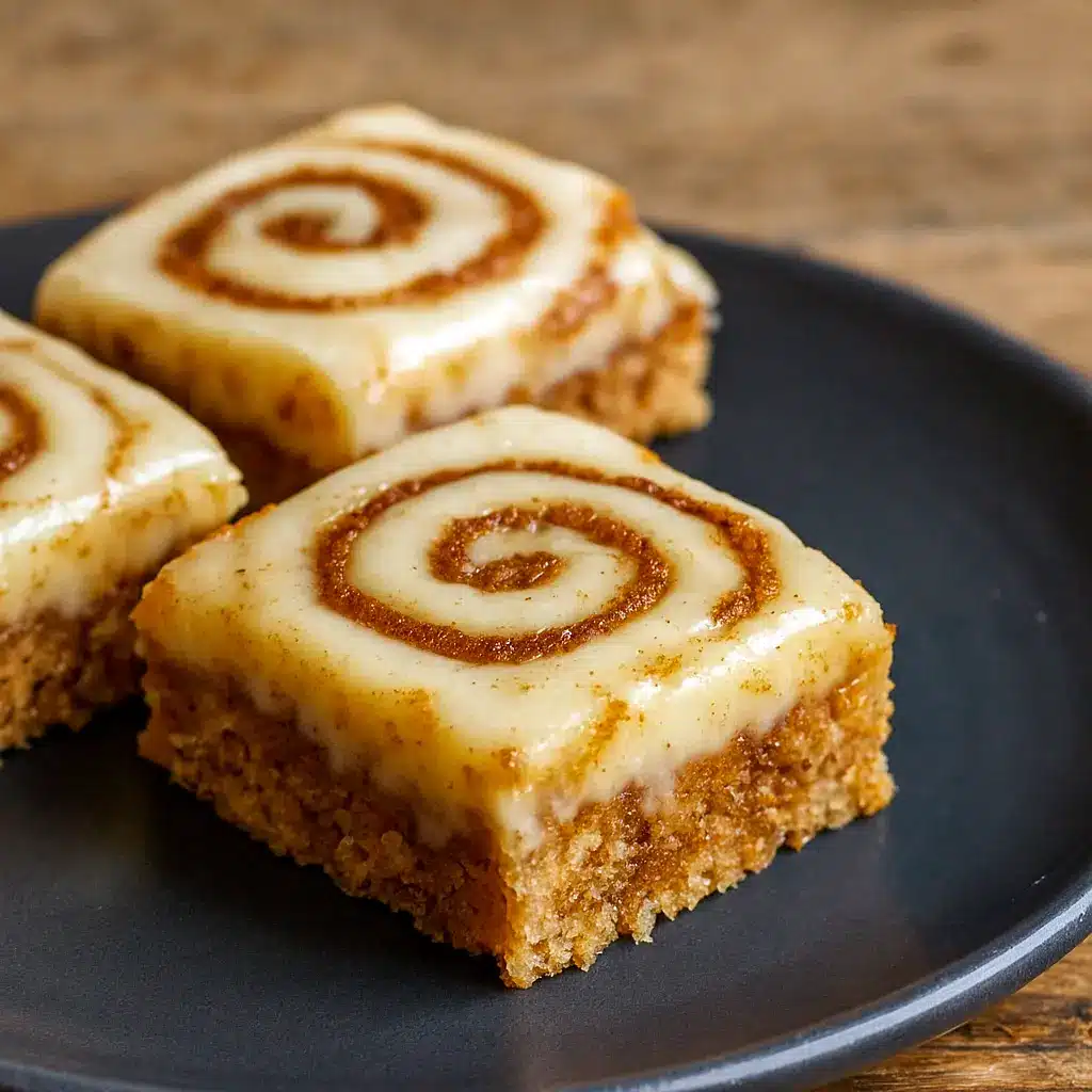 Golden-brown Cinnamon Rollups baked into soft bars with a gooey swirl, sliced and ready to serve as Easy After Dinner Snacks, cozy Cinnamon Breakfast Bars, or shareable Treats For Friends, perfect for Work Desserts and part of your favorite Bunch Recipes or Recipes For Sweet Breads. A fun option for a Dessert With Rolos or quick Easy Cheap Desserts 3 Ingredients twist.