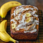 Freshly baked Cinnamon Swirl Banana Bread Homemade, sliced to reveal a cinnamon ribbon, perfect for brunch or dessert. A moist and Tasty Banana Bread option that works as a Banana Bread Recipe Two Bananas, easy for anyone Making Banana Bread from scratch. Styled as part of cozy Banns Bread Recipes, this loaf can be adapted into Churro Banana Bread, a sweet Banana Bread Roll, or served as a Banana Bread Recipe With Icing. The warm Banana Bread Recipe With Cinnamon swirl makes every bite irresistible.